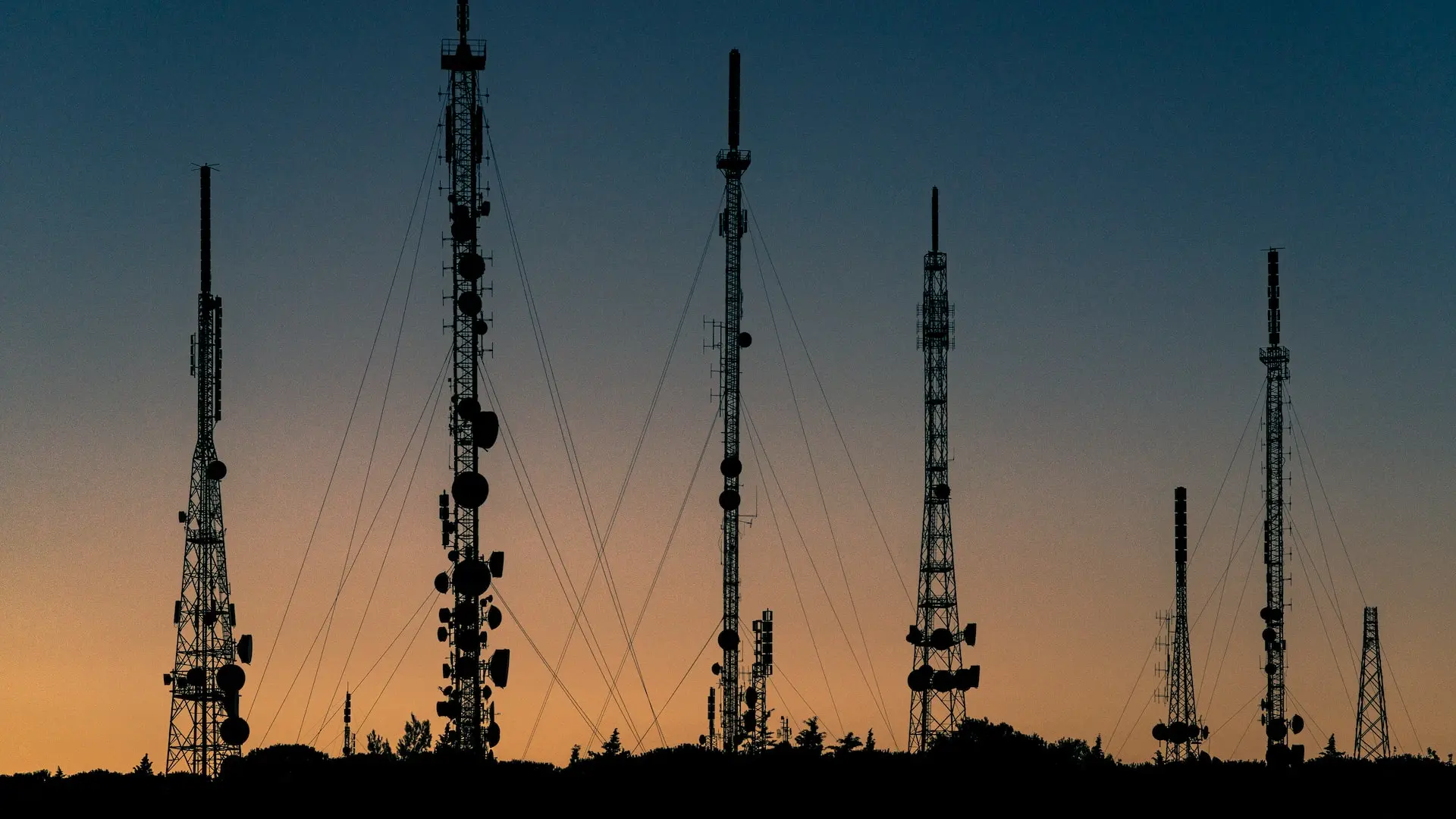 telecom towers during sunset